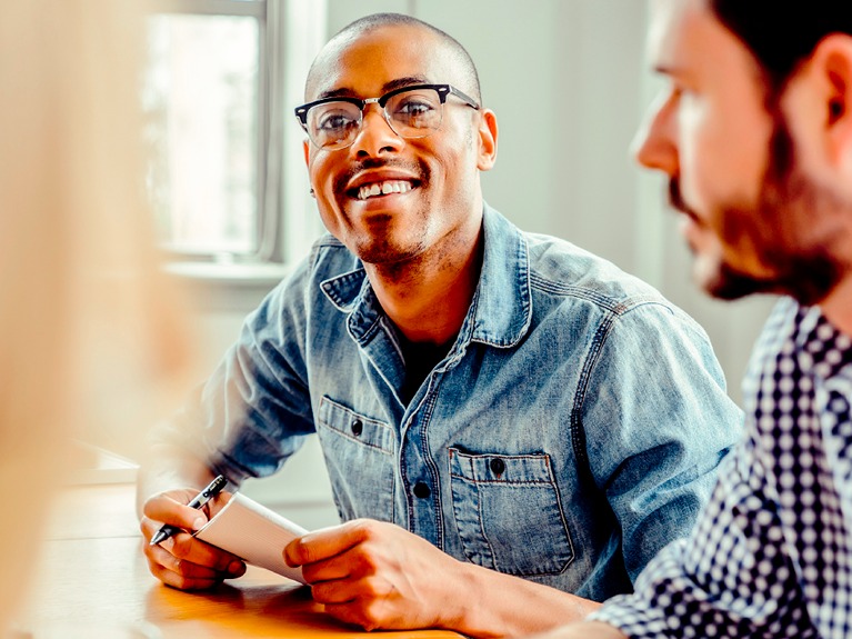 People in a business meeting looking happy