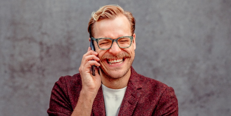 man on phone smiling