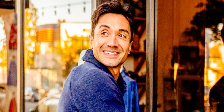 person entering a building looking happy